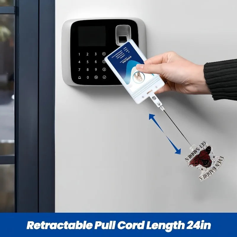 A hand is pulling a retractable cord from an acrylic nurse badge reel mounted on a wall.
