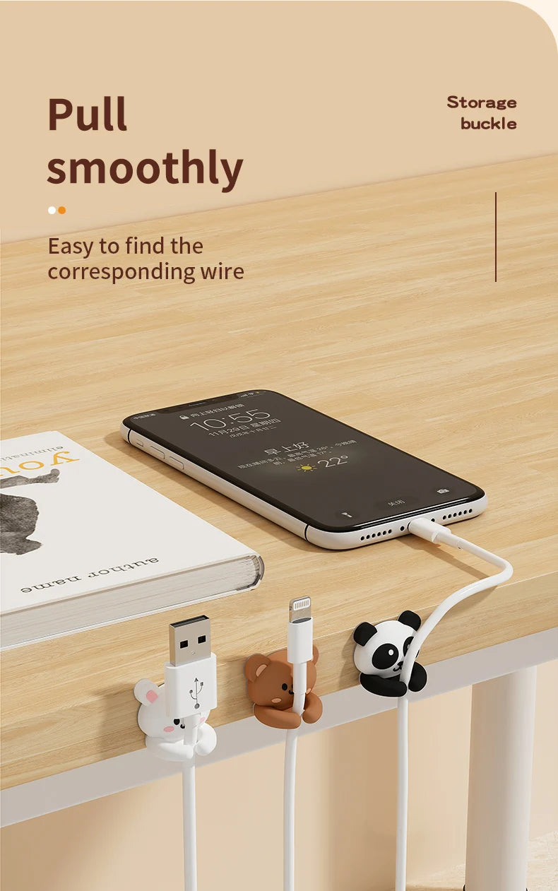 Cartoon desk cable organizers showing a white cord connecting a smartphone to a storage buckle.