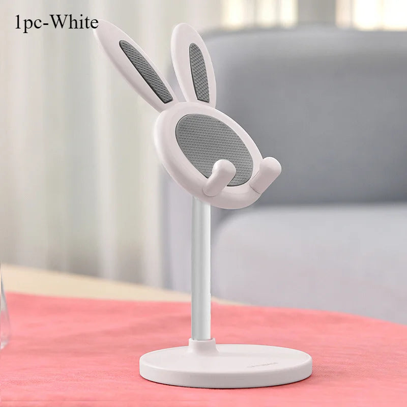 A white rabbit-shaped mobile phone stand with a mesh design, shown on a pink surface.
