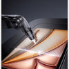 A close-up view of a tool precisely cutting a hole in a piece of tempered glass, demonstrating an accurate hole location proc