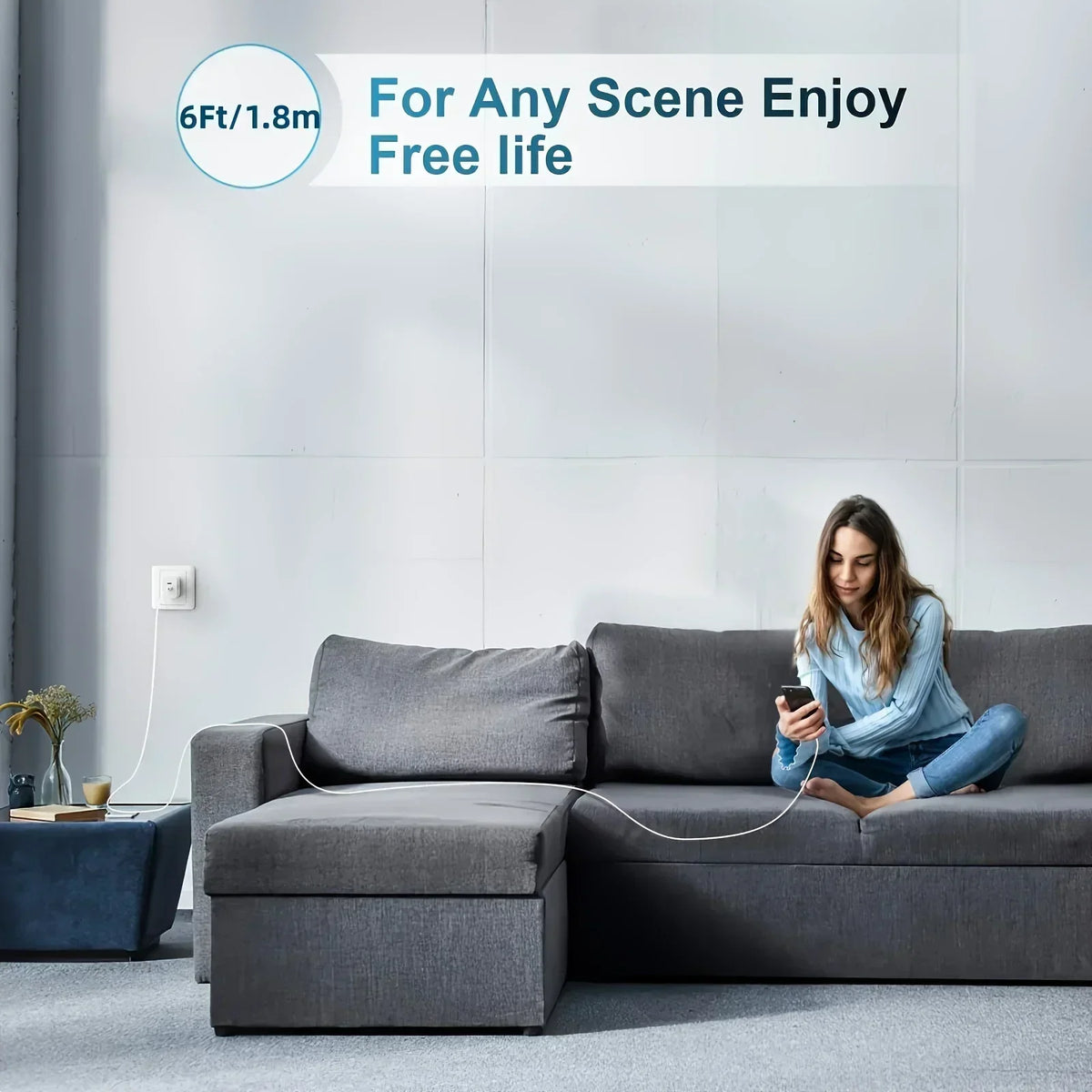 A person is sitting on a gray sofa using a 6ft lightning cable for charging.