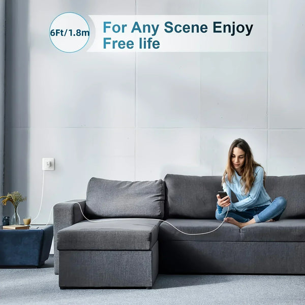 A person is sitting on a gray sofa using a 6ft lightning cable for charging.