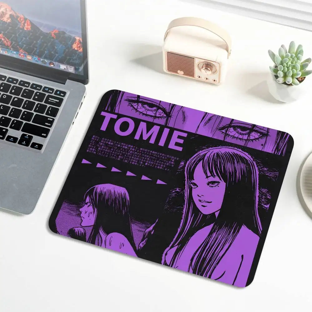 A purple and black mouse pad featuring a Junji Ito Tomie design with stylized eyes and hair.