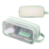 A clear plastic pencil case with a light green strap and interior compartments for pencils and brushables.