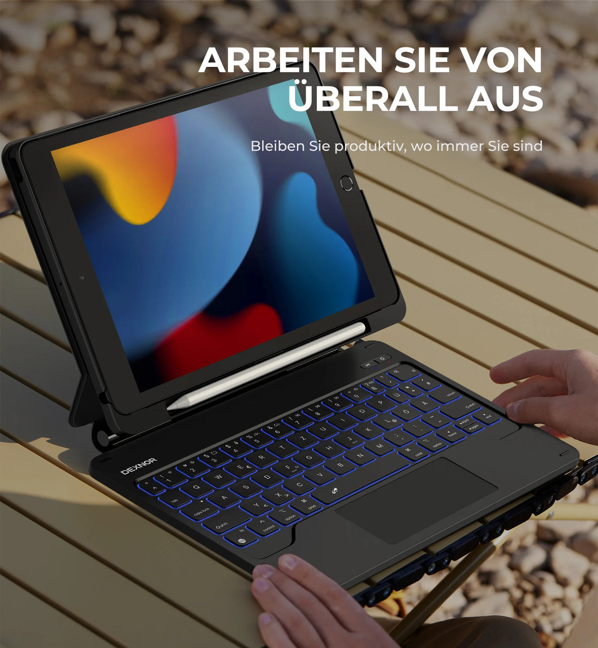 A person is using a black magnetic keyboard case for an iPad, which functions as a wireless floating stand.