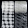 Roll of white self-adhesive hook and loop fasteners with circular adhesive pads.