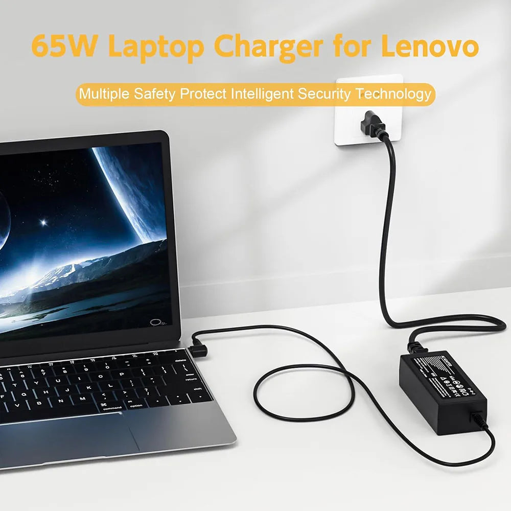 A black 65W laptop charger for Lenovo, featuring a power brick and cable, placed next to a laptop.