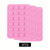 A pack of three pink silicone suction phone mounts with circular suction cups.