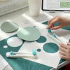 A hand is using a 360° adjustable circle cutting tool to cut a circle into a sheet of paper.