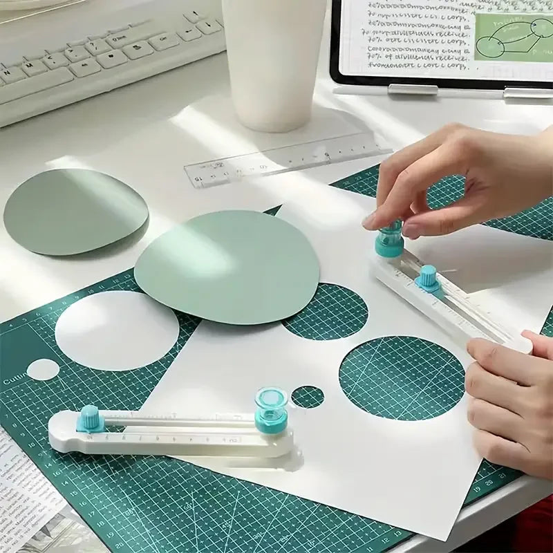 A hand is using a 360° adjustable circle cutting tool to cut a circle into a sheet of paper.