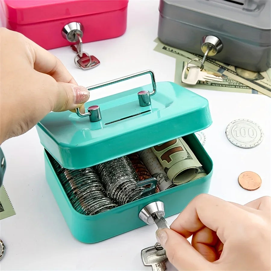 A hand opens a teal steel cash box with a key lock and removable tray, showing stacked coins.