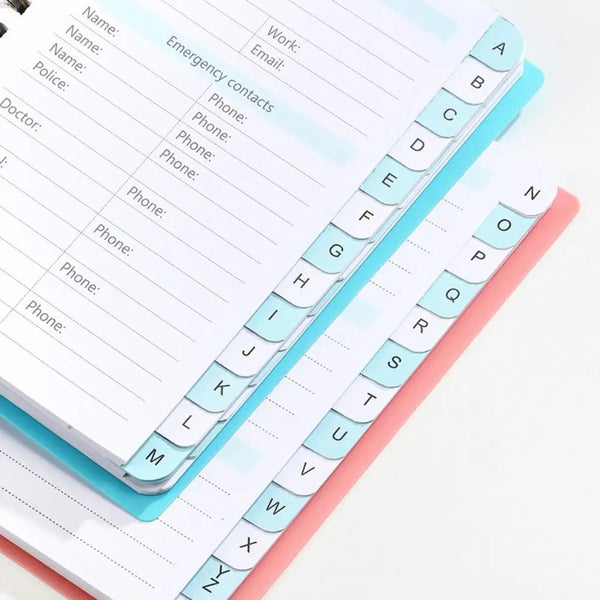 A6 password keeper notebook with alphabetical tabs showing letters A through Z