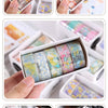 A collection of decorative transparent washi tape rolls in various floral and pastel colors displayed in small white containe