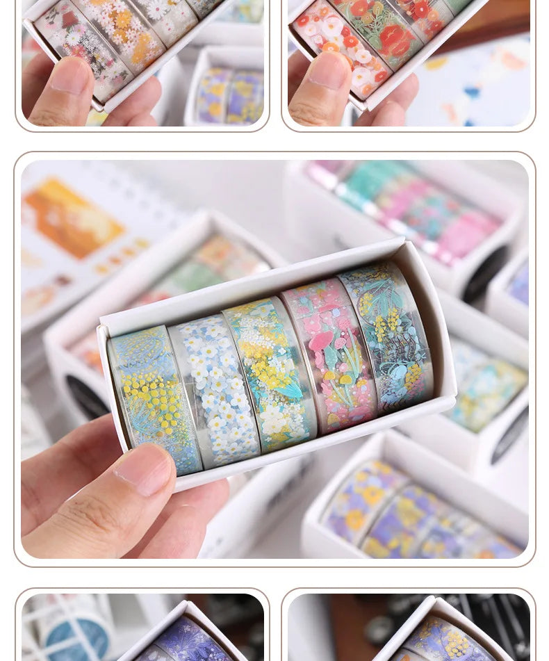 A collection of decorative transparent washi tape rolls in various floral and pastel colors displayed in small white containe