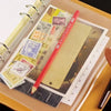 A set of ten zippered PVC binder pockets for A5/A6/A7 notebooks is shown inside a tan folder.