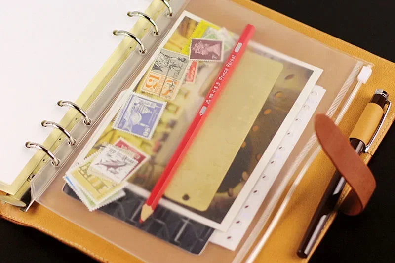 A set of ten zippered PVC binder pockets for A5/A6/A7 notebooks is shown inside a tan folder.