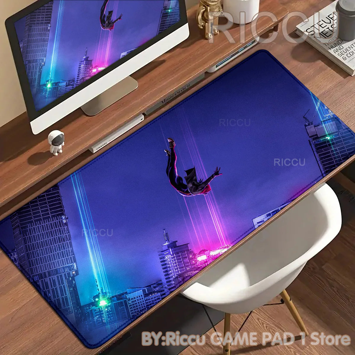 A dark blue desk mat featuring a Spider-Man character flying against a cityscape backdrop.
