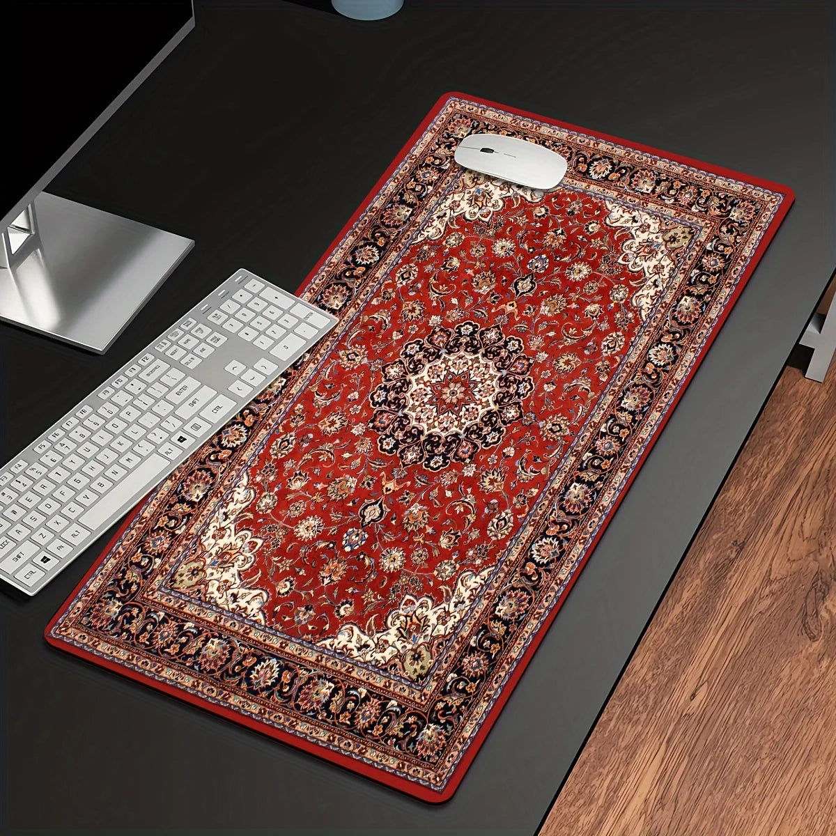 A vintage Persian rug designed as a gaming mouse pad with a non-slip rubber base placed on a dark desk.
