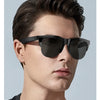A male model wearing black intelligent solar glasses with dark hair and a casual shirt.