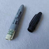 A silver marker pen with a black cap and a gold coin inside, labeled Super Shuri.
