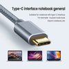 A silver Type-C interface cable with a gold connector is shown next to several laptops.