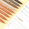 A collection of micro-pen fineliner pens in various shades of brown and black, showing different line thicknesses.