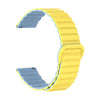 A yellow adjustable magnetic loop watch band with a silver clip shown from the side.
