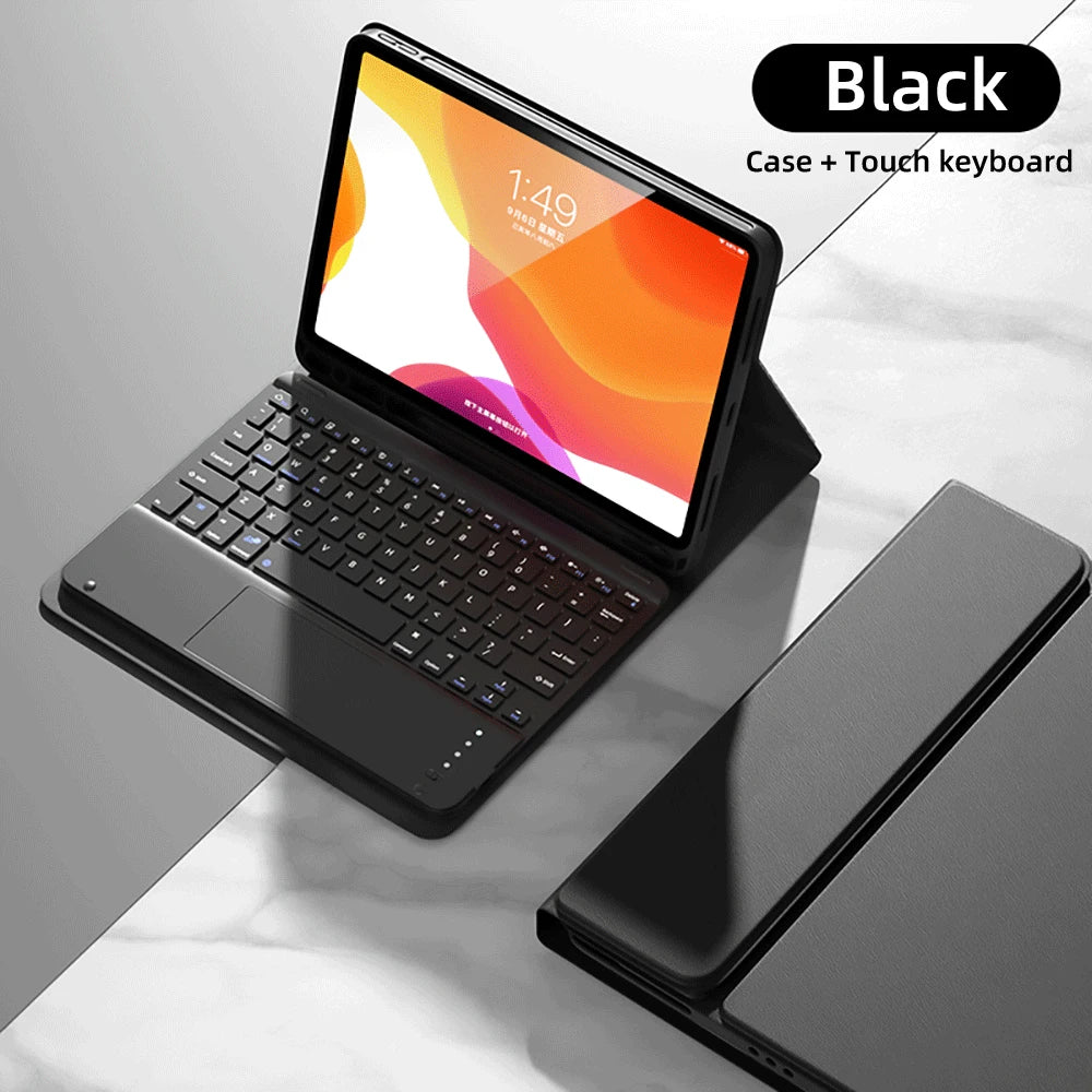 iPad noir avec clavier et souris détachables, ouvert sur une surface de marbre.