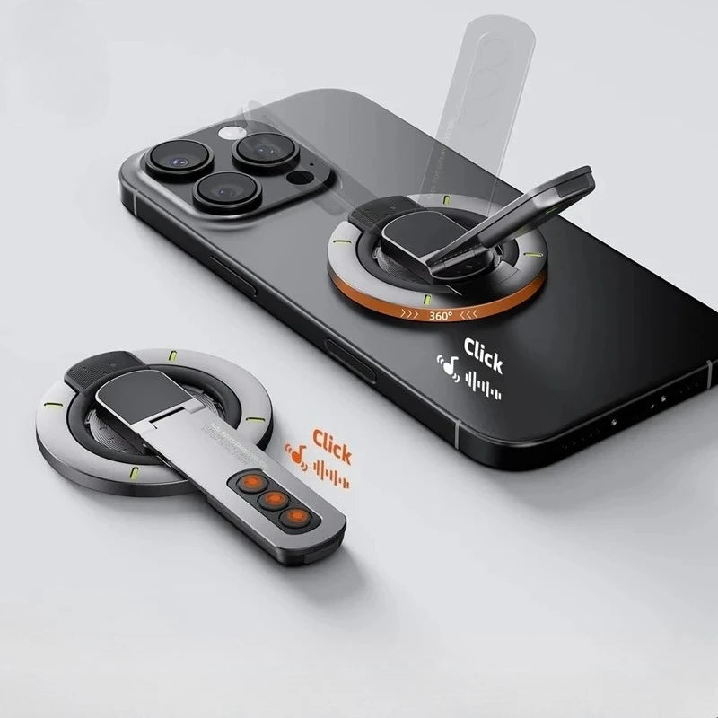 A black smartphone is shown with a magnetic ring holder attached, featuring a 360-degree rotating stand and a separate magnet
