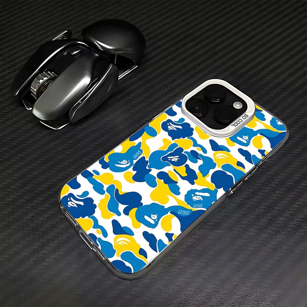 A yellow and blue leopard print anti-fall phone case for an iPhone is shown next to a black wireless mouse.