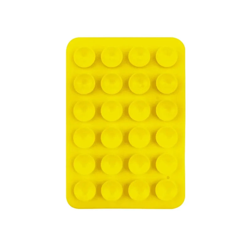 A yellow silicone suction cup mount with 24 individual cups for phone and tablet mounting.