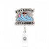 A silver acrylic nurse badge reel featuring text that reads Even Buddies Get Saddies and an illustration of a person wrapped 