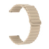A beige adjustable magnetic loop watch band shown in a curved shape.