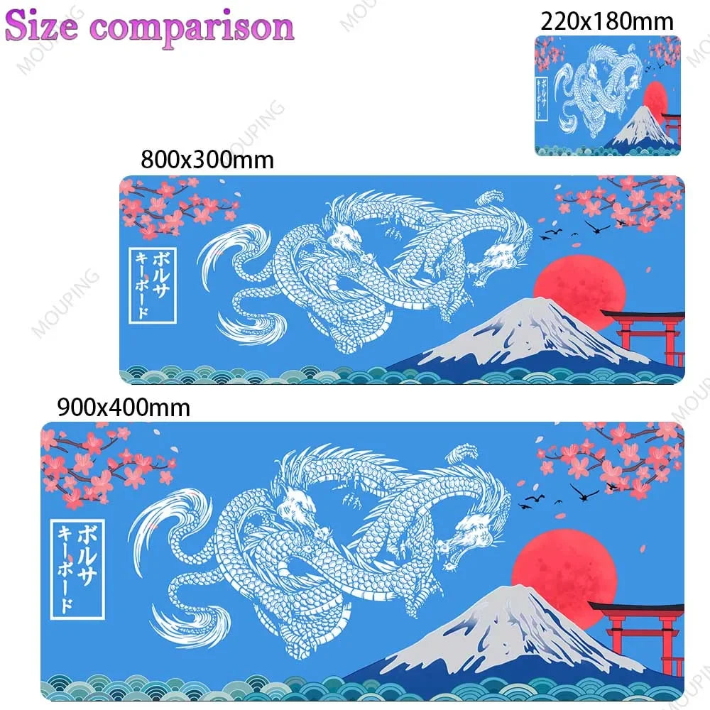 A blue desk mat featuring a Japanese dragon and Mount Fuji design with pink cherry blossoms.