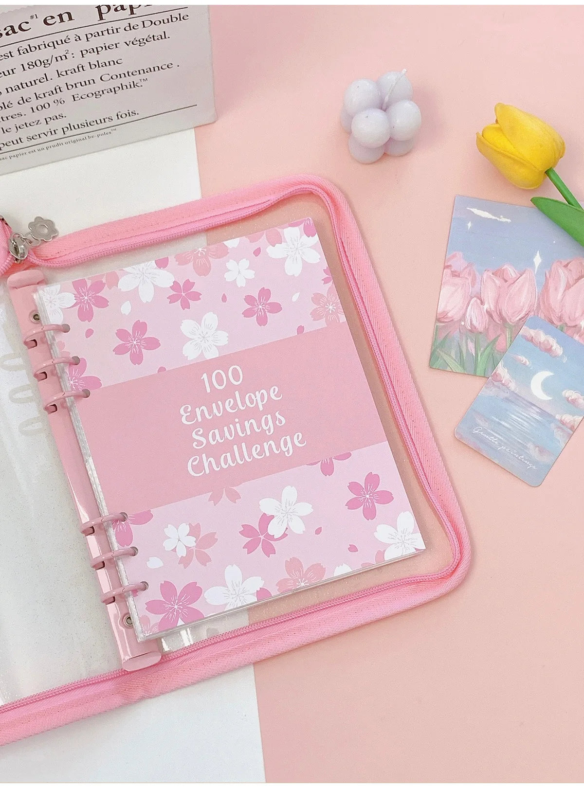 A pink A5 envelope budget binder set with a pink elastic closure and several pink envelopes on a light pink background.