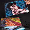 A hand holds a clear thermal laminating pouch containing a vibrant image of a man with blue flowers.