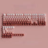 A close-up view of a keyboard featuring gradient gray double shot PBT keycaps with side printing.