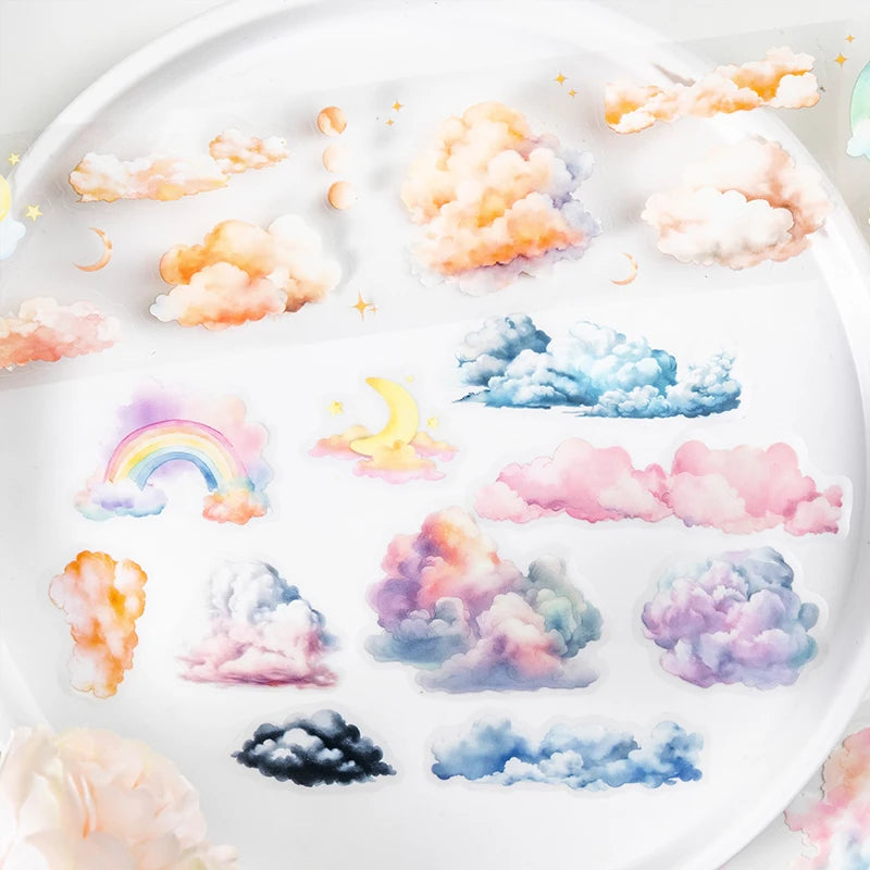 A set of decorative masking tape rolls featuring various pastel and watercolor clouds in pink, purple, blue, and yellow hues.