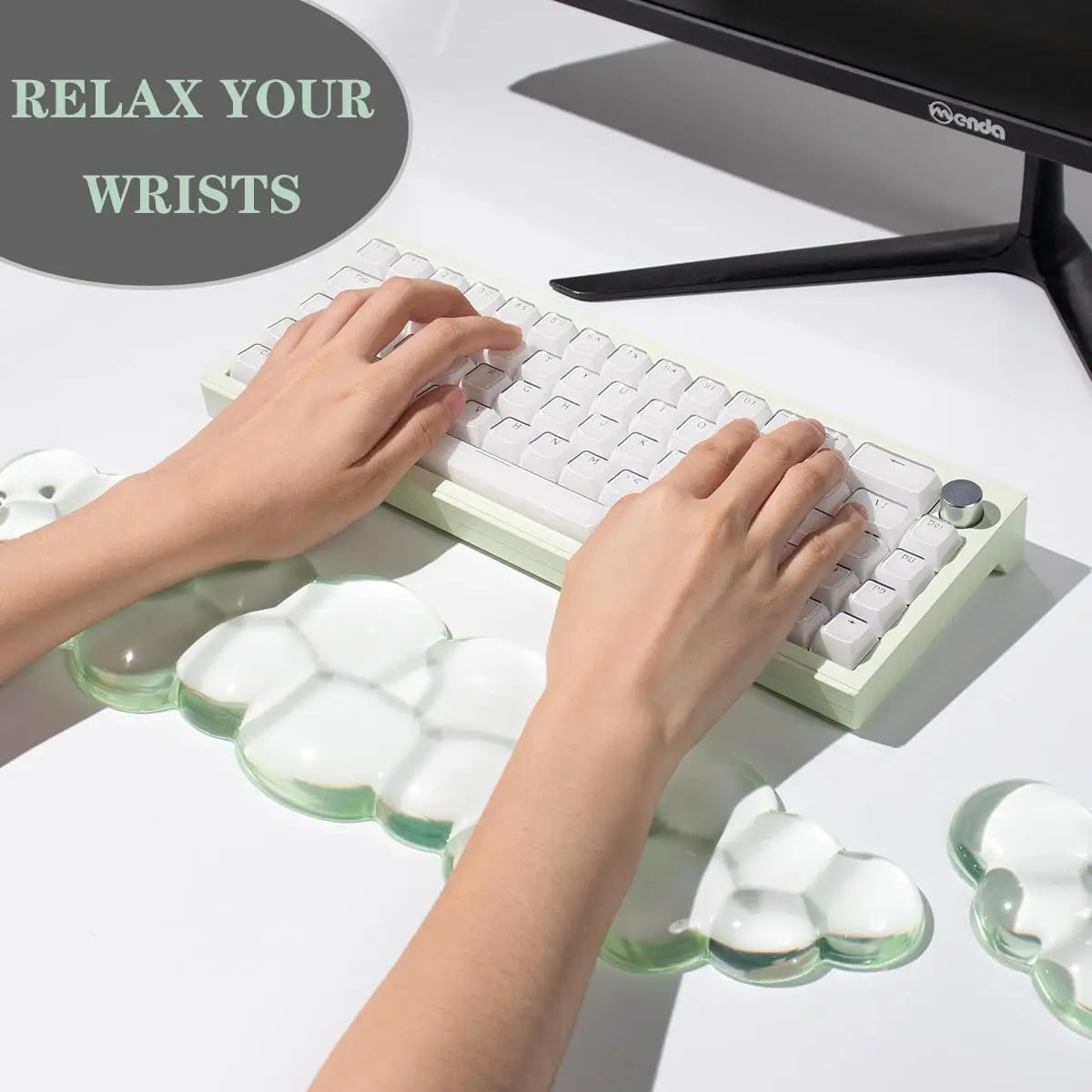 Hands resting on a white keyboard with clear silicone wrist rests for comfort