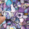 A close-up of purple magic witch stickers featuring a lavender flower and blue flowers, with a finger touching the product.
