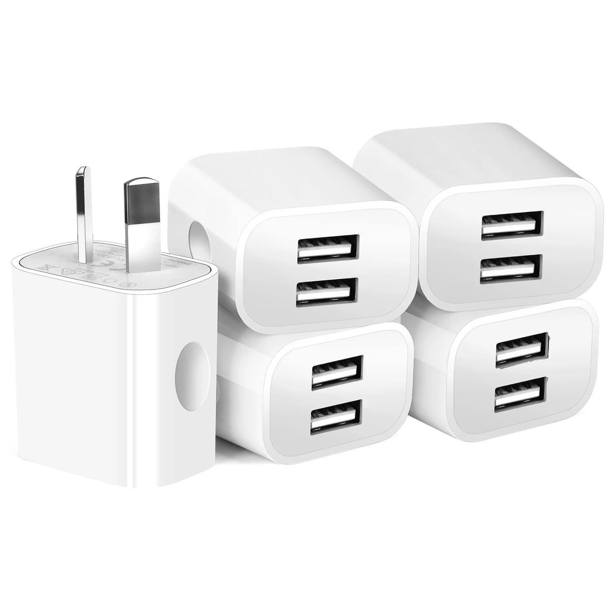 A white dual port wall charger with two detachable USB plugs is shown.