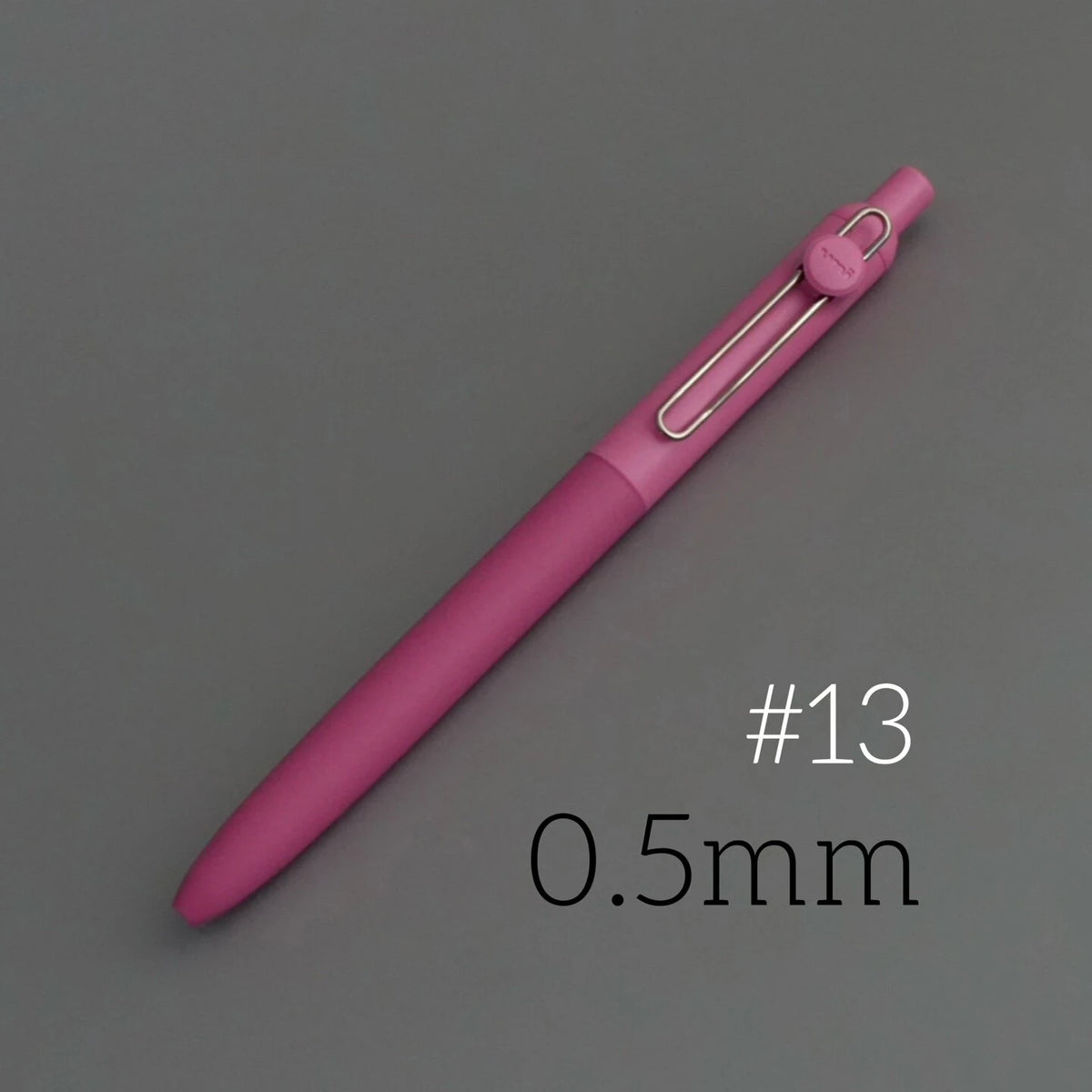 A pink precision gel pen with a silver tip is shown against a gray background, labeled #13 and 0.5mm.