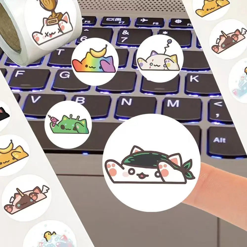 A collection of cute animal sealing stickers featuring cats and other characters placed on a laptop keyboard.