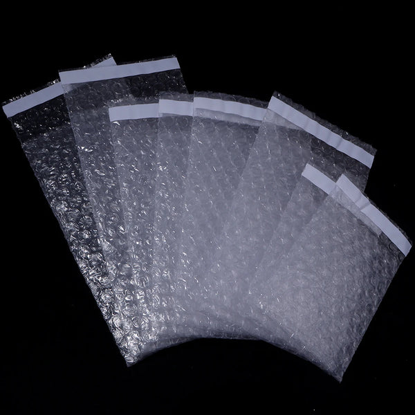A bulk pack of clear self-sealing bubble foam mailers arranged in a fan shape against a black background.