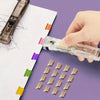 A hand is using a clear plastic clip pusher stapler set to fasten papers and small items.