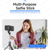 A woman is using a multi-purpose selfie stick tripod for a video call or photo, demonstrating its versatile shooting modes.