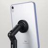 A white iPad is shown with a black magnetic phone and tablet stand attached to its side.