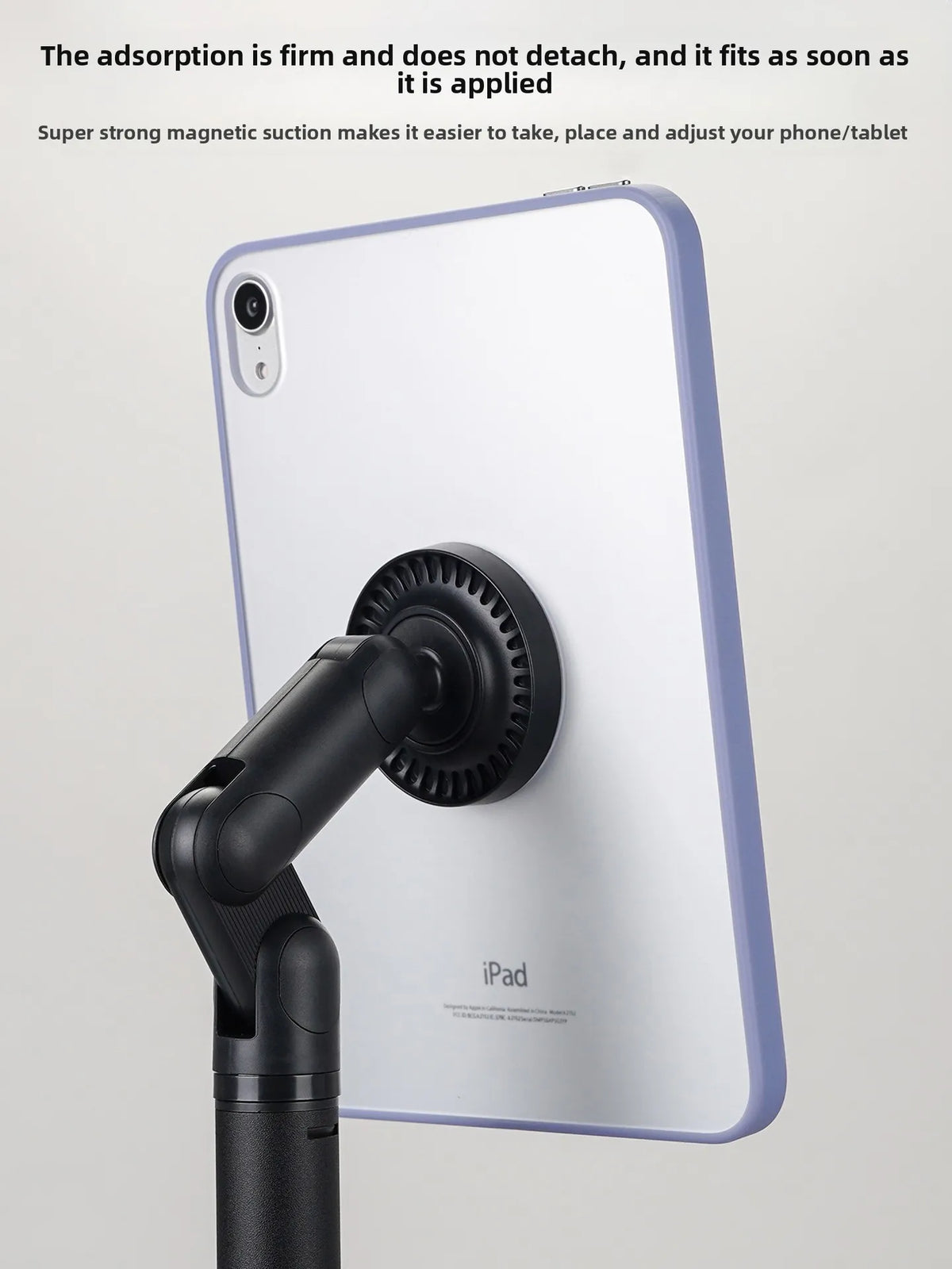 A white iPad is shown with a black magnetic phone and tablet stand attached to its side.
