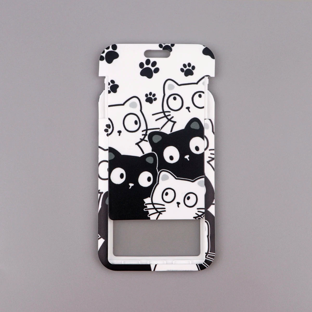 A white card holder featuring various cartoon cats in black and gray designs.
