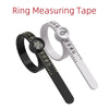 A black ring measuring tape is shown next to a silver ring with markings for sizing.